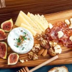 A charcuterie board illustrating the 3-3-3 rule with three types of meats, three types of cheeses, and three types of accompaniments like fruits, nuts, and spreads.